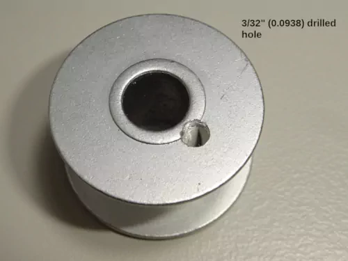 1. bobbin with hole drilled through one side (outside view)