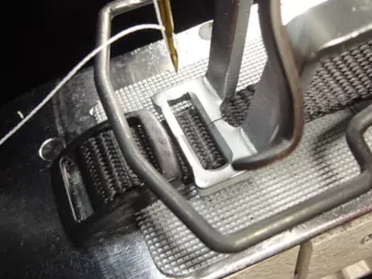 5/8-inch collar (long) clamped at the tri-glide tail (of the webbing)